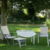 Outdoor seating area with a table and chairs set up for a meal. Produktbild-Vorschau