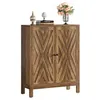 A wooden cabinet with decorative doors and items on top. Náhľad obrázku produktu