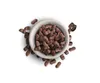 A bowl of brown kibble with some kibble scattered around it on a white background. Produktbild-Vorschau