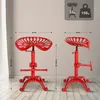 Two red tractor seat bar stools are shown from different angles, with dimensions and weight information displayed. Náhled obrázku produktu