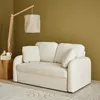 A cream-colored sofa is shown in a room with a wooden floor lamp and a textured rug. Anteprima dell’immagine prodotto