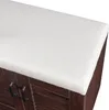 A close-up view of the top surface and upper part of a shoe cabinet with a white cushioned seat and dark wood doors. Voir les images du produit