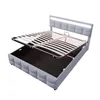 A grey upholstered bed frame with its mattress support mechanism lifted to reveal the storage compartment underneath. The headboard has integrated LED lighting. Voir les images du produit