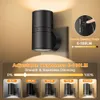 A black wall light with adjustable brightness settings shown in a marketing image. Produktbild-Vorschau