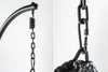 Close-up of the hanging mechanism of an outdoor hanging chair, showing the spring, chain, and carabiner. Produktbild-Vorschau