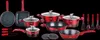 A collection of red cookware and kitchen utensils arranged on a black background. Podgląd zdjęcia produktu