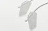 Two white plastic parts of a washing machine repair kit with strings, set against a white background. Produktbild-Vorschau