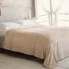 A bed with white pillows and a beige blanket. Anteprima dell’immagine prodotto