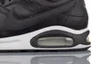 A close-up view of the side of a black Nike Air Max sneaker. Voir les images du produit