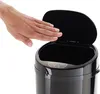 A hand is shown hovering over the open lid of a black sensor trash can. Produktbild-Vorschau