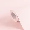 A close-up, angled shot of a roll of pink wallpaper. Produktbild-Vorschau