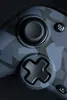 A close-up shot of a gaming controller with a camouflage pattern. Produktbild-Vorschau