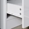 Close-up view of a white drawer with metal runners and screws, part of a piece of furniture. Produktbild-Vorschau