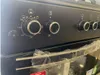A close-up view of the control panel of a black gas stove. Produktbild-Vorschau