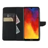 A black flip case for a Huawei Y6 2019 smartphone, shown open with cards and banknotes inside, and the phone screen displaying a colorful abstract image. Produktbild-Vorschau