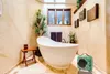 A bathroom with a freestanding bathtub, plants, and a small green heater. Náhled obrázku produktu