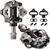 A pair of bicycle pedals and cleats are displayed against a white background. Produktbild-Vorschau