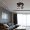 A modern living room with a sectional sofa, coffee table, and a ceiling light fixture. Náhľad obrázku produktu