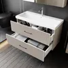 A modern bathroom vanity with a sink and two drawers, showing towels and toiletries inside. Produktbild-Vorschau