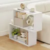A white bookshelf with books, a plant, headphones, and a clock is placed next to a cream-colored sofa. Anteprima dell’immagine prodotto