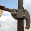 A close-up view of a mechanism on an outdoor umbrella pole against a sky background. Produktbild-Vorschau
