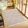 A modern living room with a hanging chair, a yellow bench, and a beige rug with a geometric pattern. Náhľad obrázku produktu