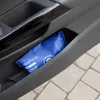 A blue sachet sits in the door pocket of a car. Voir les images du produit