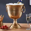 A champagne cooler filled with ice and a bottle of champagne, with strawberries and breadsticks nearby, and champagne flutes in the background. Produktbild-Vorschau