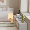 A bedroom scene with a bed and storage unit. Produktbild-Vorschau