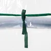 A close-up of a green ribbon tied around a clear plastic material, likely part of a greenhouse or storage unit. Voir les images du produit