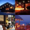 A collage of four images showing string lights used in different settings: decorating a house in the snow, a tree at night, a living room fireplace, and an outdoor patio by the sea. Náhled obrázku produktu