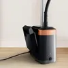 Close-up of the base of a garment steamer, showing the water tank, power cord, and control dial. Produktbild-Vorschau