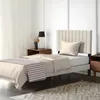 A bedroom scene with a single bed, nightstands, and a rug. Produktbild-Vorschau