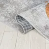 A close-up, rolled-up rug on a wooden floor. Náhled obrázku produktu