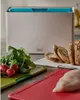 A kitchen scene with a cutting board set, bread, radishes, and chicken. Podgląd zdjęcia produktu