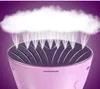 A close-up, stylized product shot of a pink handheld garment steamer emitting a cloud of steam. Náhled obrázku produktu