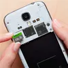 A hand is inserting a microSD card into a smartphone. Anteprima dell’immagine prodotto