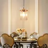 A dining table set with chairs and a chandelier hanging above. Anteprima dell’immagine prodotto