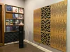 A room with a vinyl record shelf, a speaker, and acoustic wall panels. Produktbild-Vorschau
