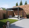 A modern outdoor patio with a black aluminum pergola, outdoor furniture, and a brick wall. Náhled obrázku produktu