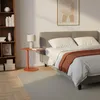 A bedroom scene with a bed, a bookshelf, and a small side table. Produktbild-Vorschau