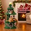 Three cats are playing on a Christmas tree-shaped cat tree in a festive living room with a fireplace and Christmas tree. Anteprima dell’immagine prodotto