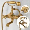 A vintage-style brass shower faucet with a handheld showerhead, mounted on a textured wall. Náhled obrázku produktu
