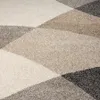 A close-up view of a textured rug with a geometric pattern. Produktbild-Vorschau
