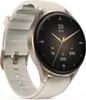 A close-up, angled view of a smartwatch with a gold bezel and a white strap, displayed against a white background. Voir les images du produit