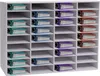 A white organizer unit filled with colorful binders. Náhled obrázku produktu