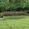 A raised garden bed filled with flowering plants in a garden setting. Produktbild-Vorschau