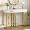 A white and gold console table with two drawers, decorated with a vase of flowers, a framed picture, and a lamp. Anteprima dell’immagine prodotto