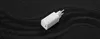 A white Xiaomi Mi 65W Fast Charger with GaN Tech is placed on a black, textured surface with wavy patterns. Anteprima dell’immagine prodotto