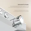 Close-up of a modern chrome shower faucet with a temperature dial and buttons, with German text overlay explaining a safety feature for children. Anteprima dell’immagine prodotto